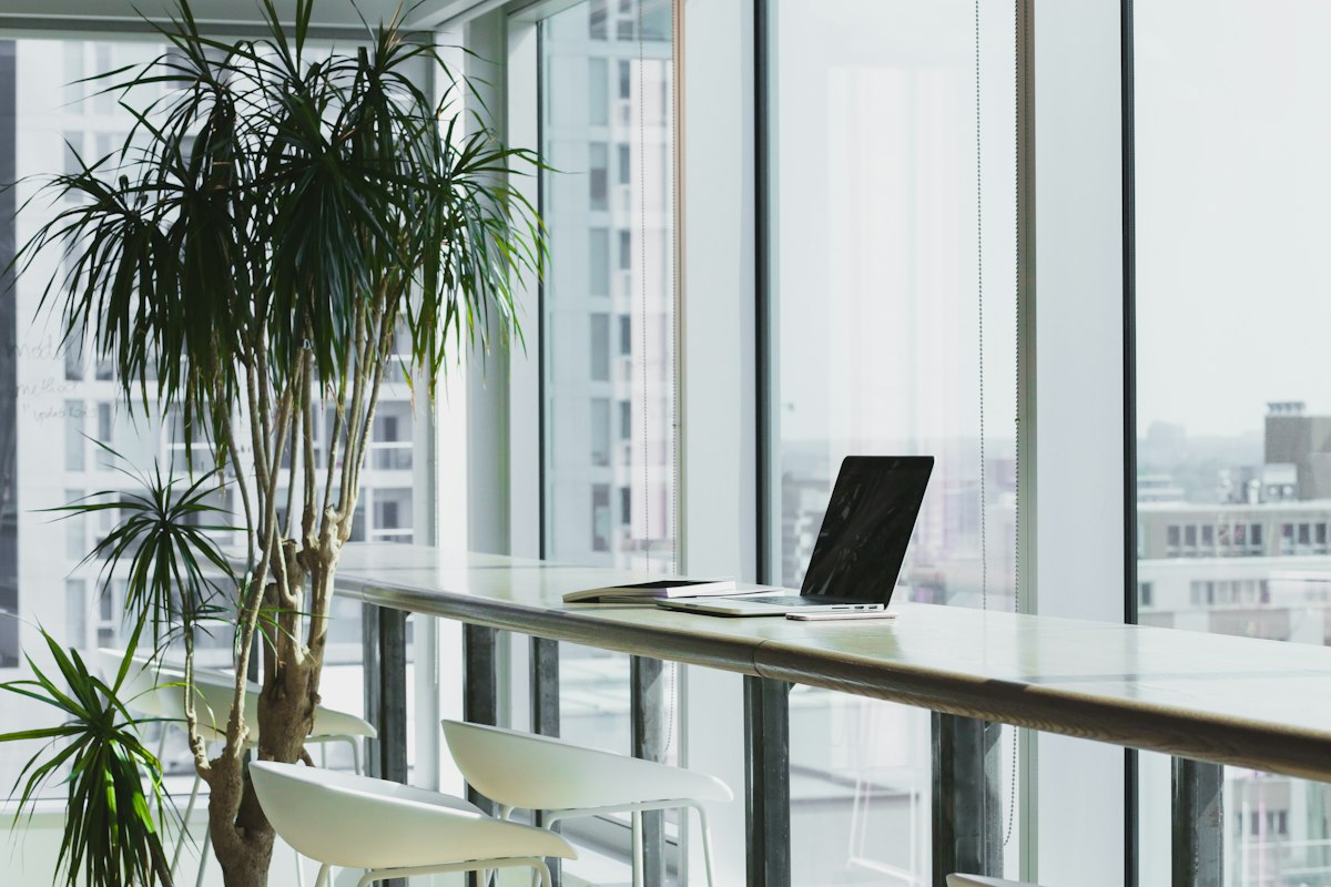 Minimalist editorial studio desk overlooking city skyline